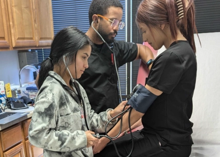 medical assistant students training to capture patient vitals