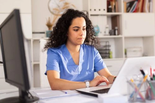 medical assistant using computer to populate patient electronic health records